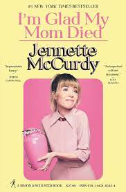 Off the shelf, Pale yellow book cover showing actress Jennette McCurdy wearing a pale pink dress holding a bright pink urn on a fuchsia background with the title I'm Glad My Mom Died written in pink above her name, which is written in black shadowbox type lettering.