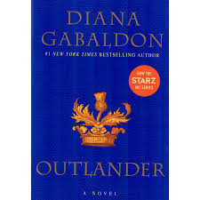 Off the shelf, Solid dark blue book cover with Diana Gabaldon's name in all capital letters in an orange font across the top with an orange crown or royal type design with a gold thistle coming up out of the center of the crown, all centered on the page with the title of the book Outlander underneath this figure, also in a light orange all capital font. This is the first book in her Outlander series.