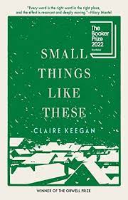 Off the shelf, book cover for Claire Keegan's novella Small Things Like These, winner of the Booker Prize in 2022, white background with a dark green sky showing slanted rooftops of houses covered with white snow with snow falling in the dark green sky, with the title in white capital letters centered on the page with the author's name also in white capital letters centered below the title