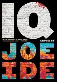 Off the shelf, Book cover for IQ by Joe Ide, first in series with neighborhood sleuth Isiaiah Quintabe, black cover with large capital letters for the title IQ with blue and orange capital letters showing the author's name. All of the letters are formed with bricks and the title has a slight blood splatter on the upper right-hand corner of the Q.