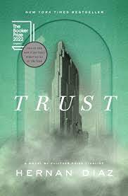 Book cover for Trust by Hernan Diaz, 2023 Pulitzer Prize winner, sage green cover showing prominent fictional New York City skyscraper in foreground with other skyscrapers in muted gray and white shades in the background with the italicized title in white all capital letters across the center and the author's name below that at the bottom of the cover, centered, also in white all capital letters