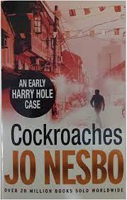 Book cover for Cockroaches by Jo Nesbo showing scene from a Thai street with the image of a man walking, his back to the camera, wearing dark clothes