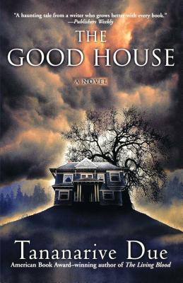 Book cover for The Good House by Tananarive Due showing a large spooky house on the top of a hill in what looks like a forested area with dark clouds that seem to come out of the top of the mansion