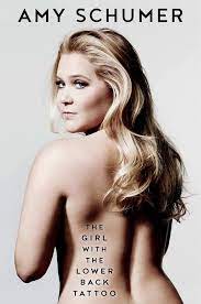 Book cover for The Girl with the Lower Back Tattoo, by Amy Schumer, showing the author, topless, looking over her left shoulder, her blond hair down her back, with the title printed on the lower left side of her back