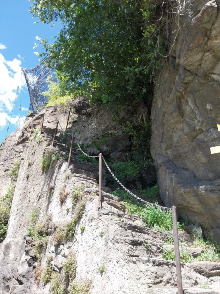 magic carpet ride steep uneven steps carved into the side of a mountain with a thin chain railing on the left-hand side