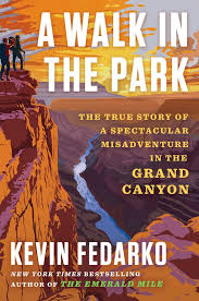 Book cover for A Walk in the Park The True Story of a Spectacular Misadventure in the Grand Canyon by Kevin Fedarko showing two people on a promontory overlooking the Grand Canyon in a stylized photo in brown and orange hues