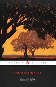 Book cover for East of Eden by John Steinbeck Penguin Classics edition with the bottom third of the cover in solid black with the name of the author and title. Above that is the Penguin Classics logo in a white stripe. Above that is a drawing of a lone man, in profile, walking while he appears to be reading a book. There is a large tree to his left, rendered in black, with a second tree in the background, rendered in orange-black tones, all set against an orange sky.