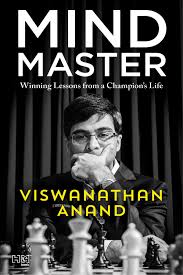 Book cover for Mind Master: Winning Lessons from a Champion's Life by Viswanathan Anand (Vishy). There is a black and white photo of the author, with his left hand across his mouth, as he concentrates on a chess board, which is shown in front of him, with the white pieces in the foreground and the black pieces in the background. he is wearing a dark suit and a watch, along with glasses. He has dark hair and is entirely engrossed in the game. The title is in very large white font above his picture, with the subtitle in small white type below it
