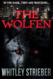 Book cover for The Wolfen by Whitley Strieber. At the top of the cover, in white letters, it says In the Dark, They are Watching. Below that, all on a black background, is an image of the New York City skyline at night, the lights on in buildings. Below that in large red font is the title The Wolfen, across the top-third of the cover. Below that is an image of wolf-life creature with dark black ears, a gray and black face, and reddish orange eyes staring straight out from the cover. The author's name is in gray font along the bottom of the book cover.