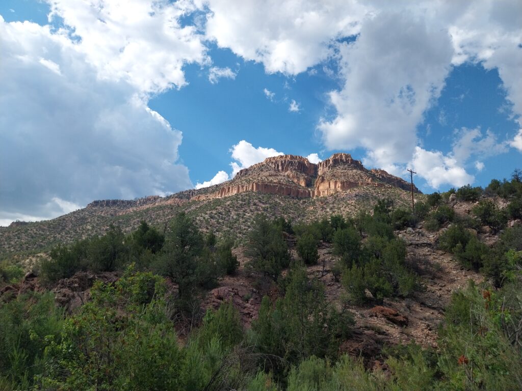 summertime photograph of a northern New Mexico mesa with bright clouds in a blue sky, easy livin'?
